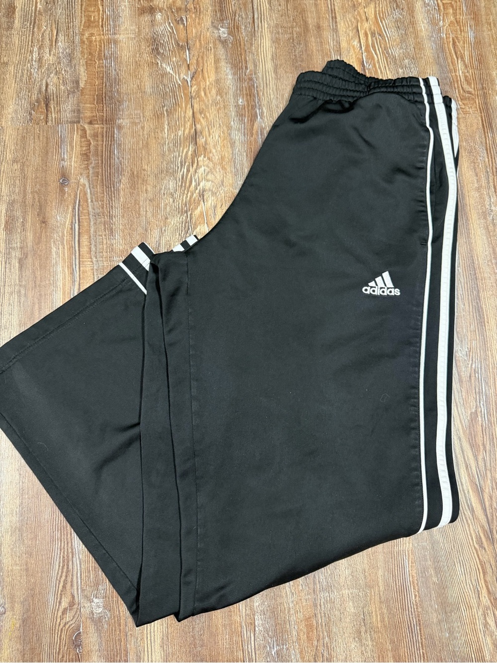 Black Adidas wide leg track pants with white stripes